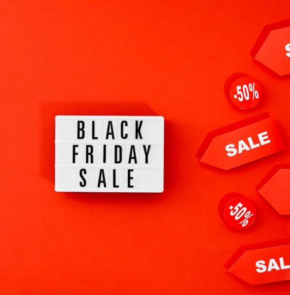 Eye-catching Black Friday sale display with discounts on a bold red background.